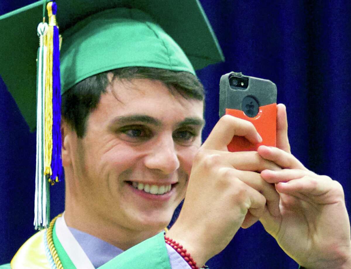 Nevan Swanson uses his iPhone to capture panoramic images of the scene before him before delivering his salutatory address during New Milford High School's June 21 commencement ceremony for the Class of 2014 at the O'Neill Center on the westside campus of Western Connecticut State University in Danbury.
