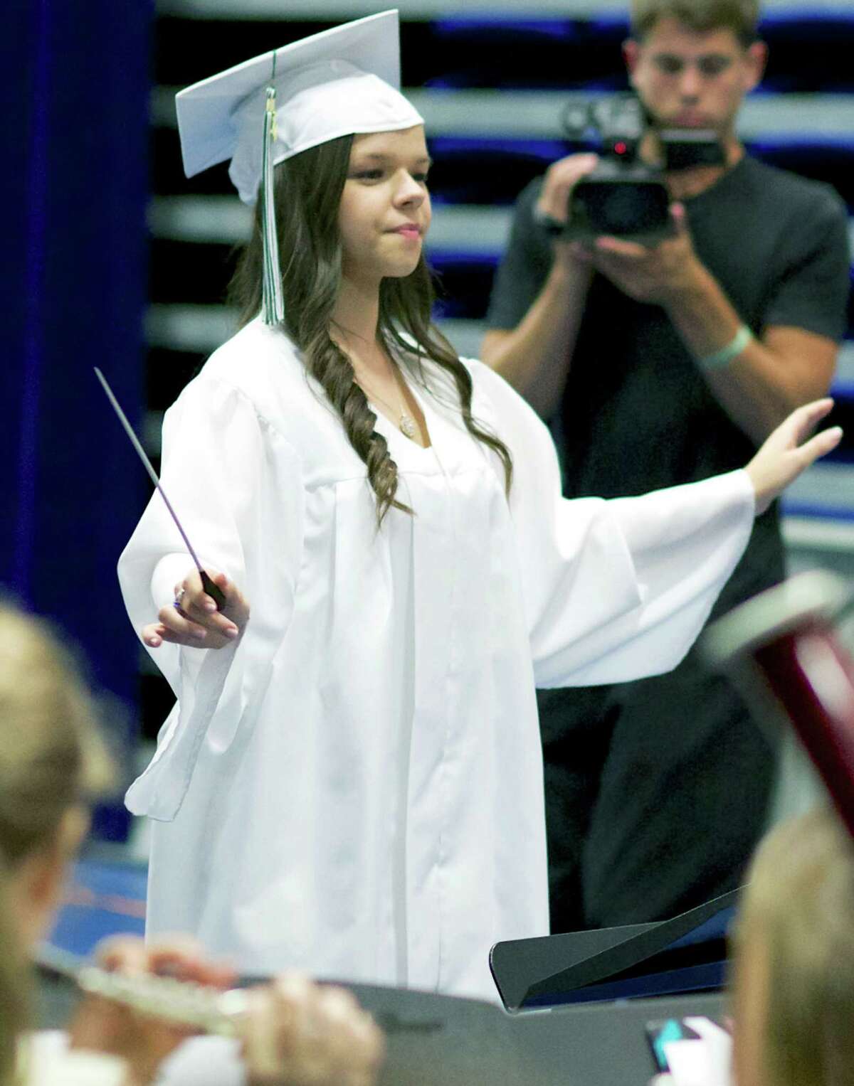 Graduate Katie Schaffer leads the NMHS orchestra in the Star Spangled Banner during New Milford High School's June 21 commencement ceremony for the Class of 2014 at the O'Neill Center on the westside campus of Western Connecticut State University in Danbury.