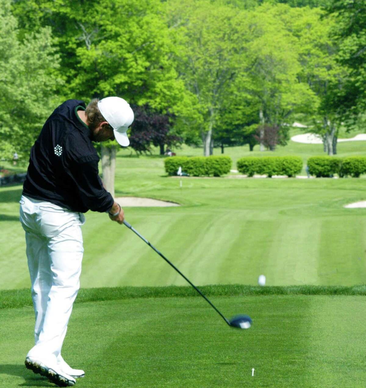 Cole Case of the Green Wave delivers a perfect swing on his tee shot at the picturesque 9th hole for New Milford High School golf during the South-West Conference tournament, May 29, 2014 at Ridgewood Country Club in Danbury.