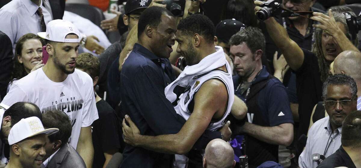 Tim Duncan shares a moment with his old teammate David Robinson after the Spurs wrapped up the franchise's fifth NBA championship against the Heat. They played on the Spurs' 1999 and 2003 title teams.