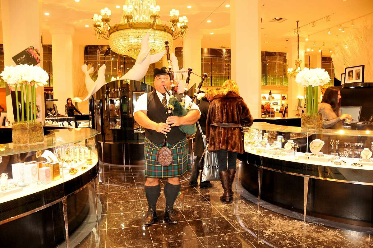 The Ogilvy Piper makes his way through the jewelry section of the iconic department store at noon every day.