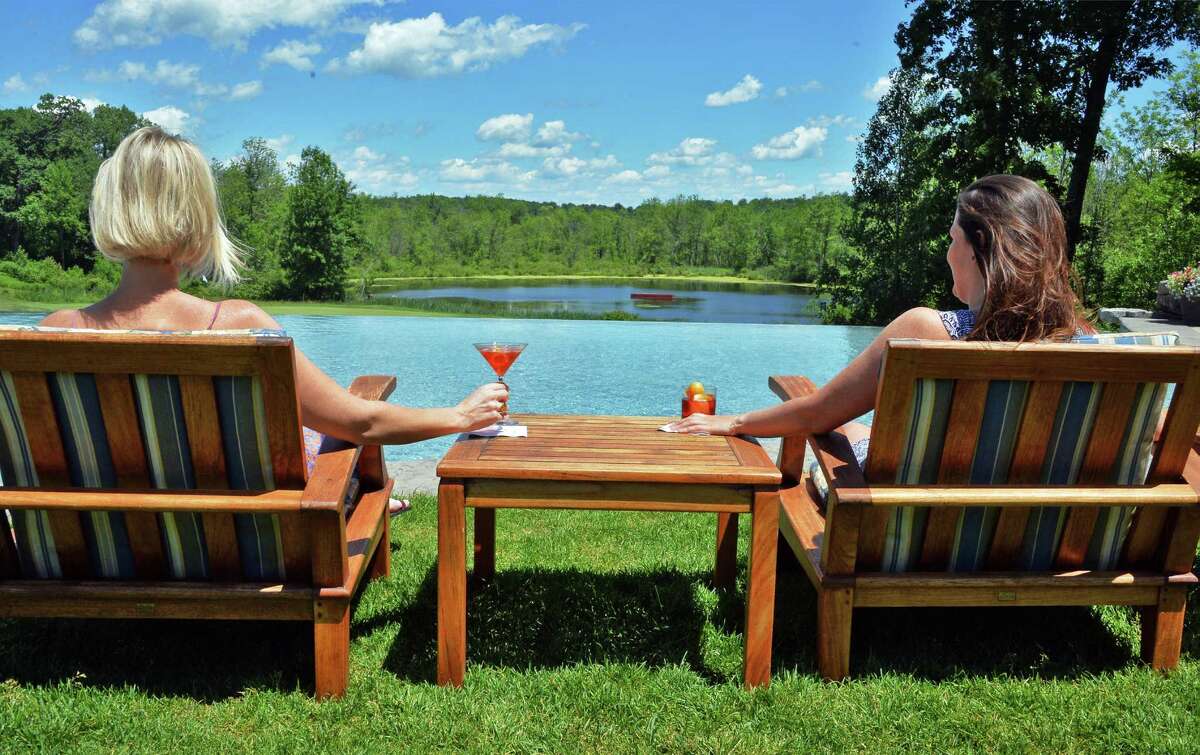 Enjoying a Classic Negroni, left, and a Kingston Negroni on the patio at Saratoga National Thursday June 19, 2014, in Saratoga Springs, NY. (John Carl D'Annibale / Times Union)