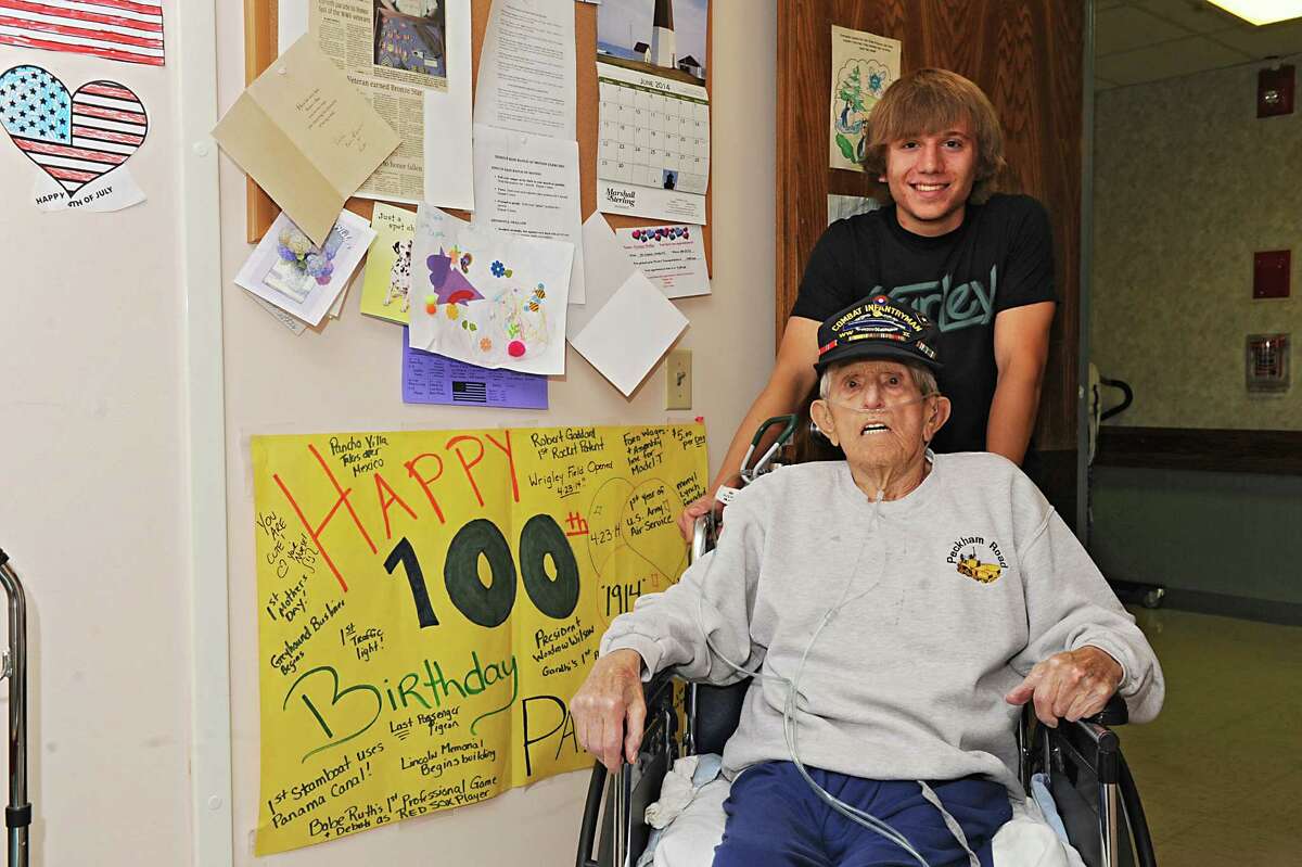 Devin Stark, 19, smiles for a photo with his 100-yr-old great- grandfather George Hulka at the Wesley Community Center on Tuesday, June 24, 2014 in Saratoga Springs, N.Y. George never graduated from high school because he left for World War II, but will graduate this week at Schuylerville with his great-grandson, Devin. (Lori Van Buren / Times Union)