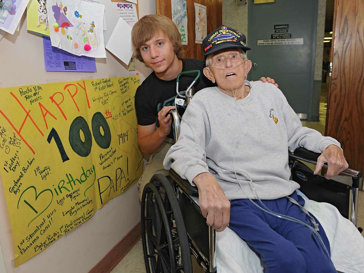 Devin Stark, 19, smiles for a photo with his 100-yr-old great- grandfather George Hulka at the Wesley Community Center on Tuesday, June 24, 2014 in Saratoga Springs, N.Y. George never graduated from high school because he left for World War II, but will graduate this week at Schuylerville with his great-grandson, Devin. (Lori Van Buren / Times Union)