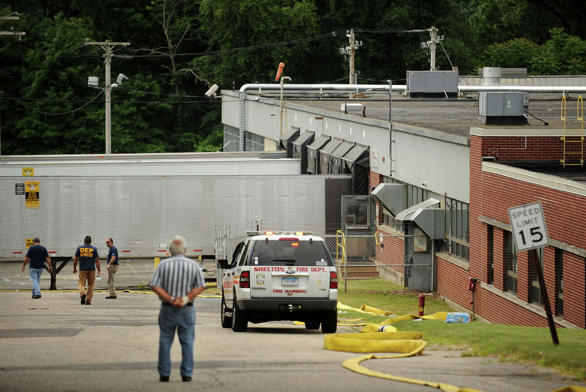 The state Department of Environmental Protection and Shelton Fire are on scene in the aftermath of an early morning fire at the Latex International factory at 510 River Road in Shelton, Conn. on Thursday, June 26, 2014.