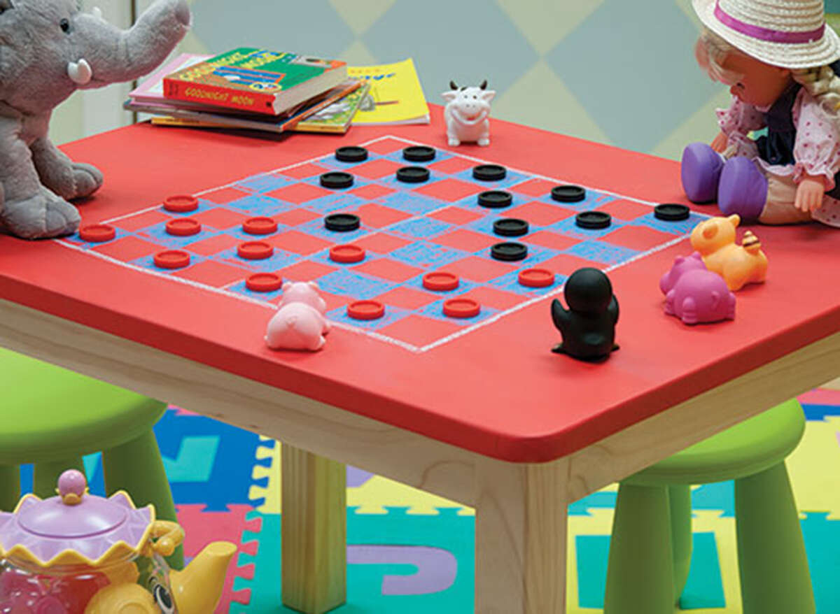 A child-size table painted with chalkboard paint can be turned into a table for games and activities.