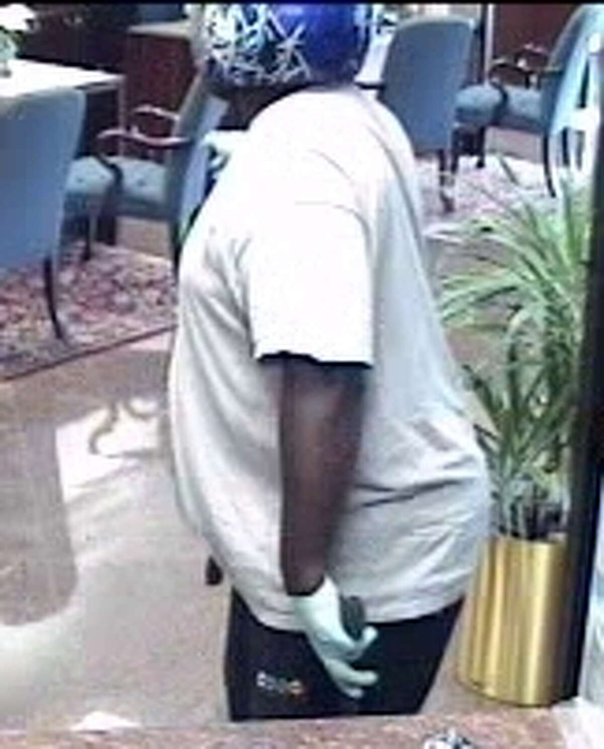 A surveillance photo of the Thursday morning robbery at an International Bank of Commerce branch in Montrose. One of the suspects is shown wearing a motorcycle helmet.