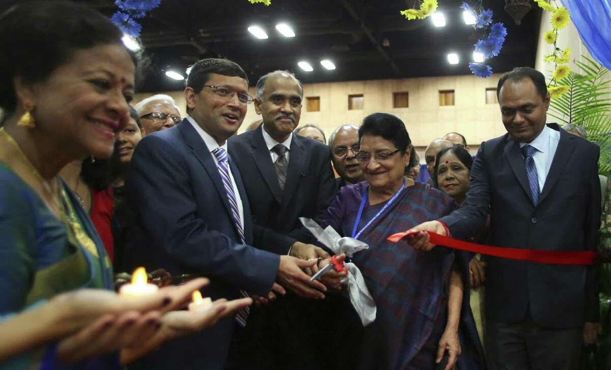 Jayesh Shah, president of the American Association of Physicians of Indian Origin (second from left); Parvathaneni Harish, consul general of India in Houston; and Jayshree Mehta, president of the Medical Council of India, cut a ceremonial ribbon to open the convention.
