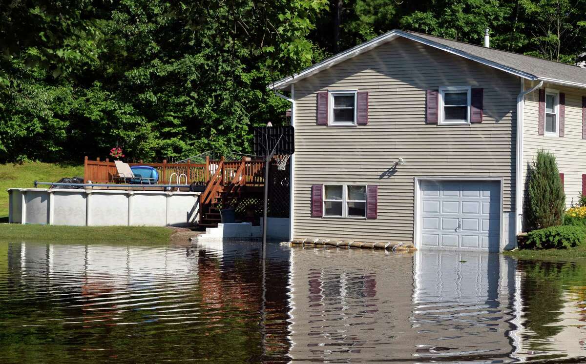 Flood waters from Wednesday's downpour reaches a home on New Castle Road Thursday, June 26, 2014, in Halfmoon, NY. (John Carl D'Annibale / Times Union)