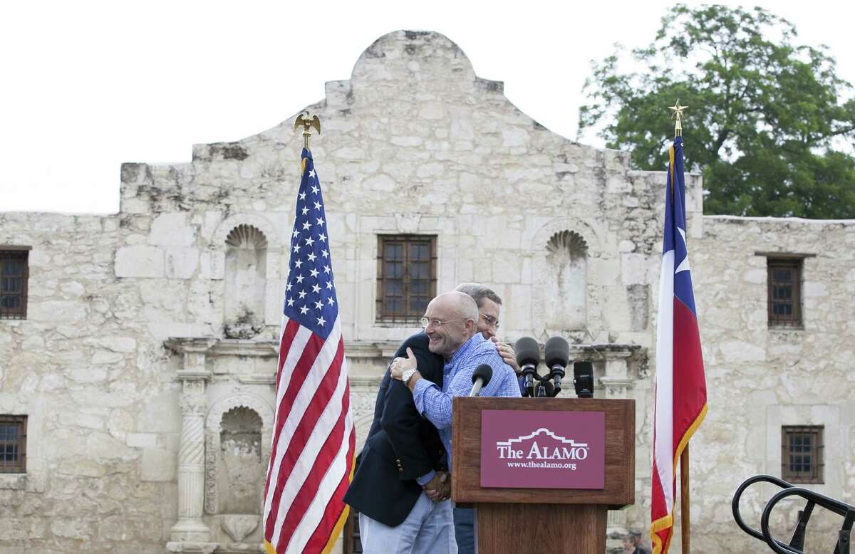 Texas Land Commissioner Jerry Patterson and singer Phil Collins embrace during the remarks in front of the Alamo.