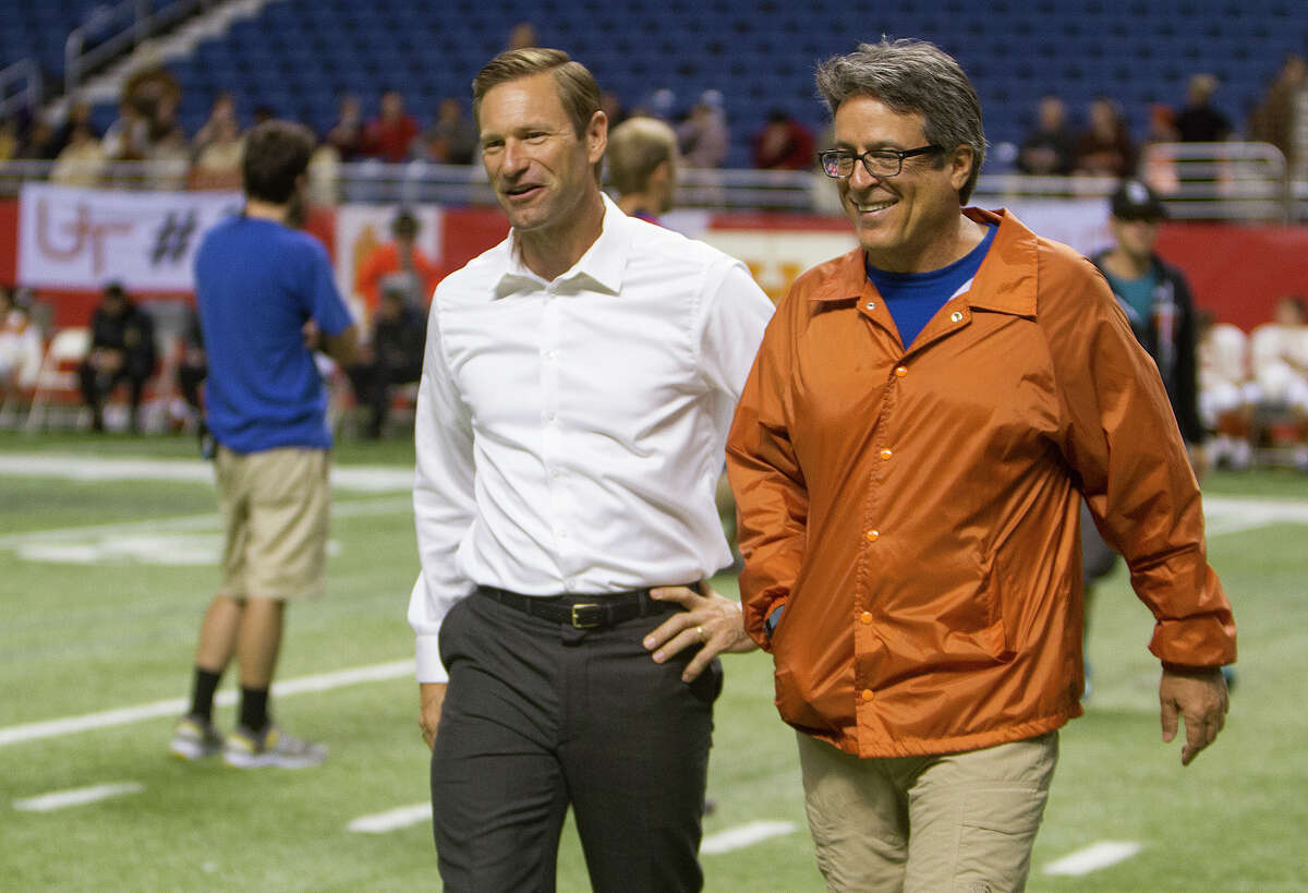 Aaron Eckhart (left) and director Angelo Pizzo, June 26, 2014 on set in the Alamodome during the filming of My All American, a film about former University of Texas (UT) football player Freddie Steinmark. Eckhart plays UT Longhorns head coach Darrell Royal in the film.