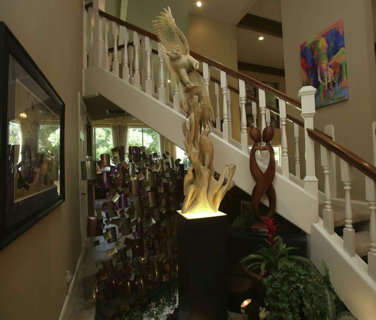 Sculptures and paintings decorate the entryway in the home of Linda and Jim Beard.