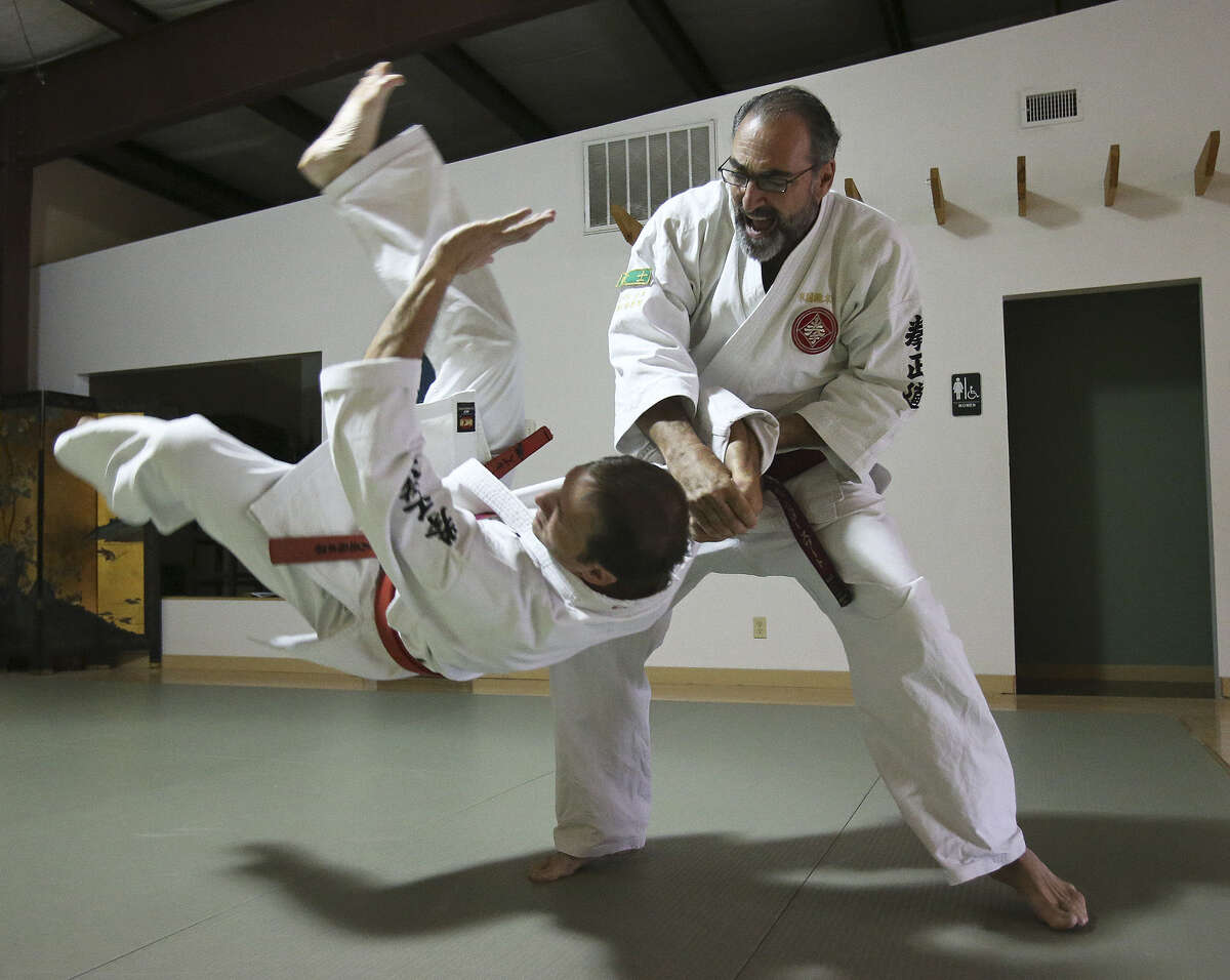Winslow Swart performs a maneuver with Von Shields at his kenseido training center in San Antonio. Swart leaves for Japan on Sunday in an effort to ascend to the highest rank of the martial art masters. His trials will last a week there.