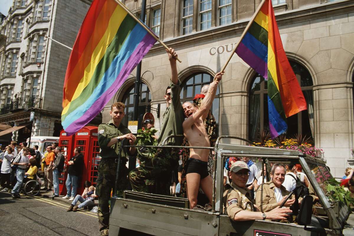 1997: Men wave rainbow flags from a Jeep during the London Lesbian, Gay, Bisexual, and Transgender Pride event in London, England.