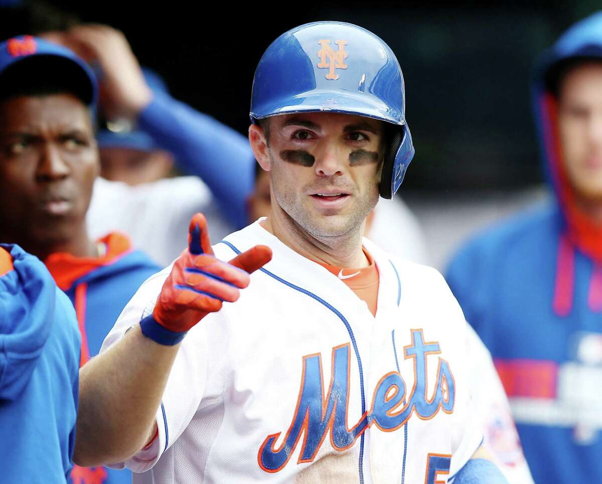 NEW YORK, NY - MAY 28: David Wright #5 of the New York Mets celebrates in the dugout after his solo home run in the sixth inning against the Pittsburgh Pirates on May 28, 2014 at Citi Field in the Flushing neighborhood of the Queens borough of New York City. (Photo by Elsa/Getty Images)