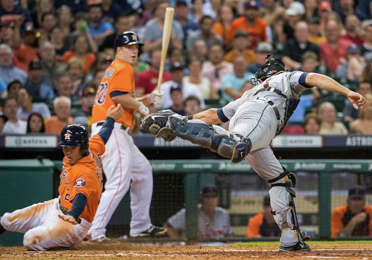 Astros second baseman Jose Altuve gets past the tag from Tigers catcher Alex Avila as he steals home with Matt Dominguez batting in the fifth inning Friday night.