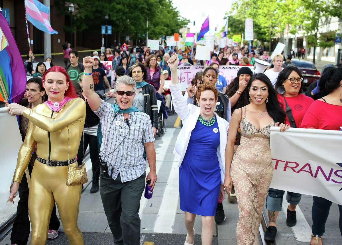 Marchers make their way down Broadway street as part of the Trans* Pride Seattle 2014 march and celebration on Friday, June 27, 2014.