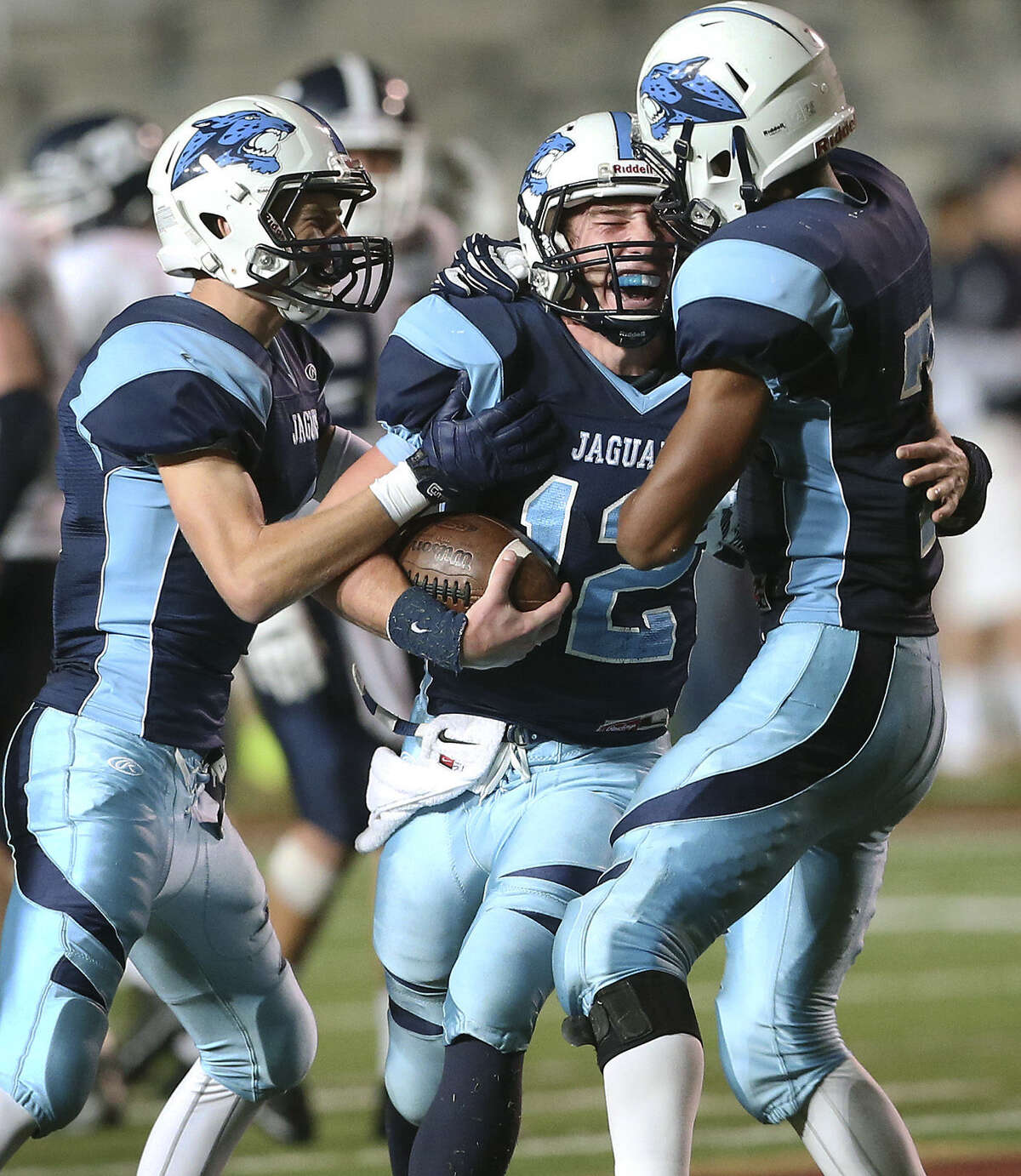 Coleman Fowler (from left), Hunter Rittimann and Darion McElhannon celebrate a TD during Johnson's bidistrict upset of Smithson Valley.