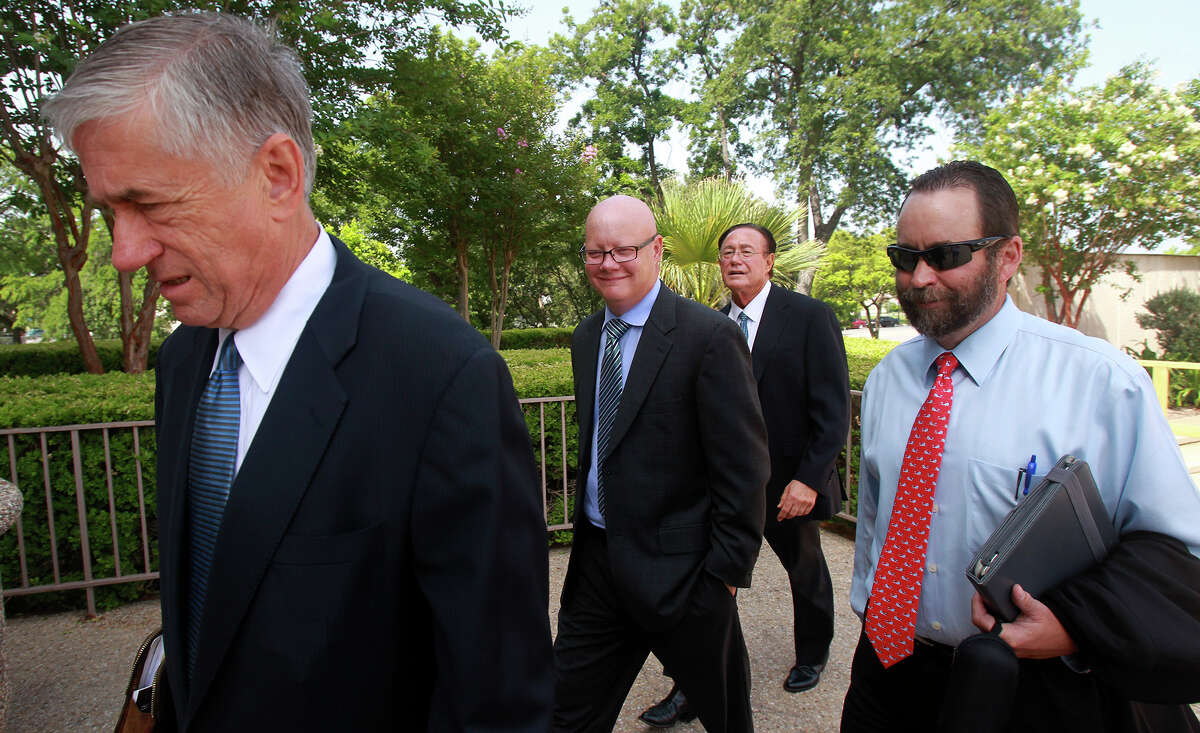 Former State District Judge Angus McGinty (center, bald) enters the Federal Courthouse Monday June 30, 2014 in San Antonio. McGinty is charged with accepting bribes.