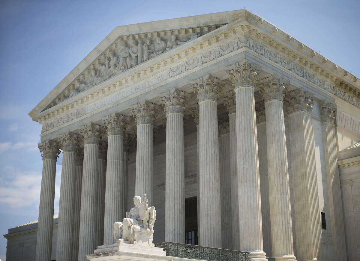 The Supreme Court building following the court's decision on the Hobby Lobby case in Washington, Monday, June 30, 2014. The Supreme Court says corporations can hold religious objections that allow them to opt out of the new health law requirement that they cover contraceptives for women.(AP Photo/Pablo Martinez Monsivais)