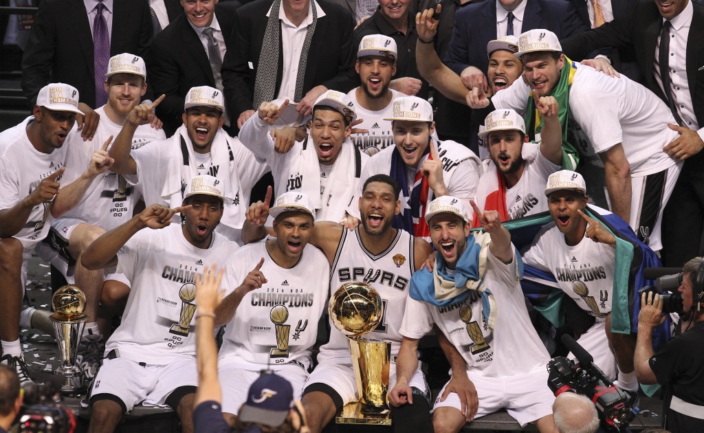 The San Antonio Spurs celebrate with the Larry O'Brien trophy