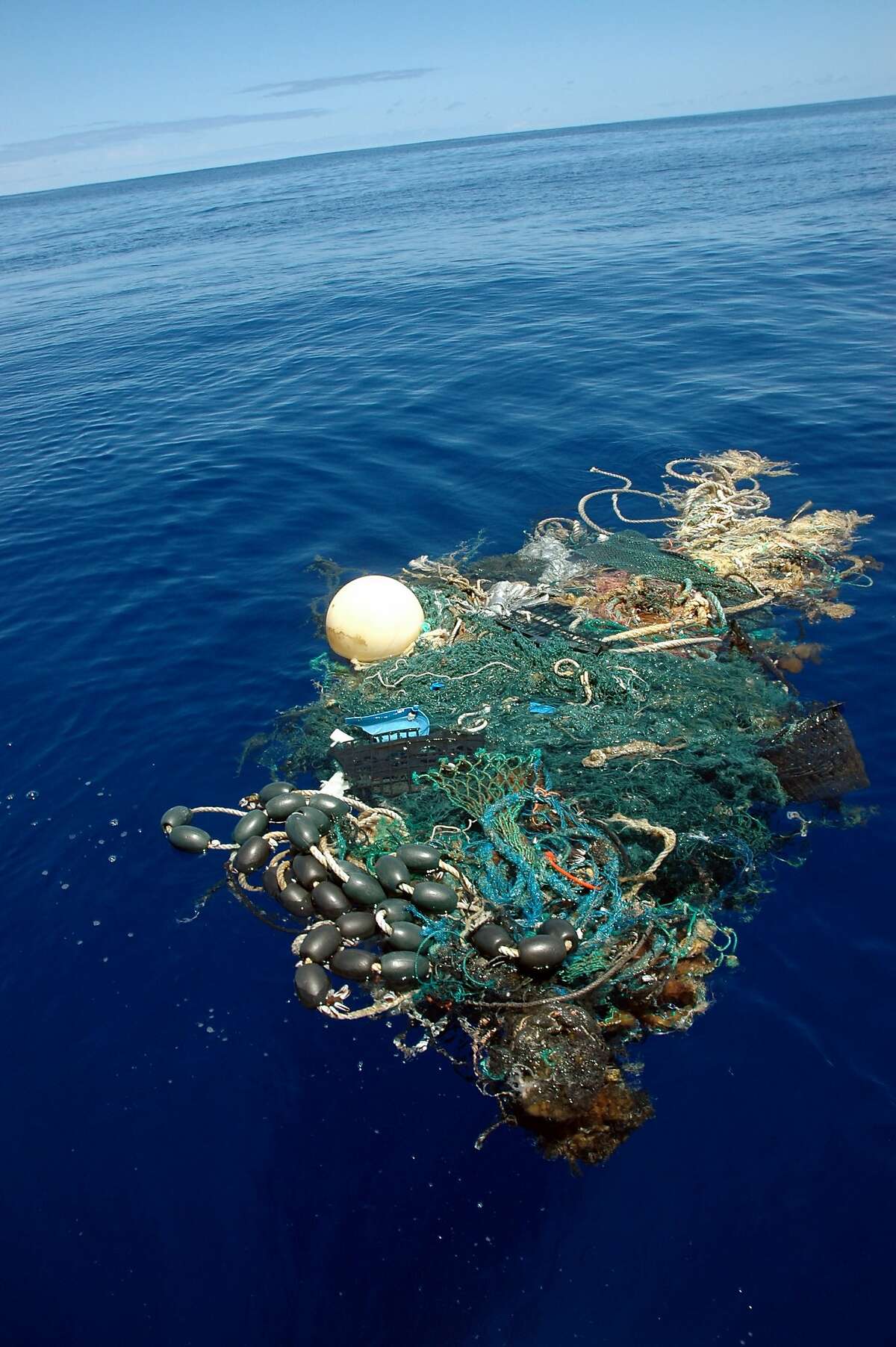 FILE- This Aug. 11, 2009 file image provided by the Scripps Institution of Oceanography shows a patch of sea garbage at sea in the Pacific Ocean. A study released by the Proceedings of the National Academy of Sciences on Monday, June 30, 2014, estimated the total amount of floating plastic debris in open ocean at 7,000 to 35,000 tons. The results of the study showed fewer very small pieces than expected. (AP Photo/ Scripps Institution of Oceanography, Mario Aguilera, File) NO SALES
