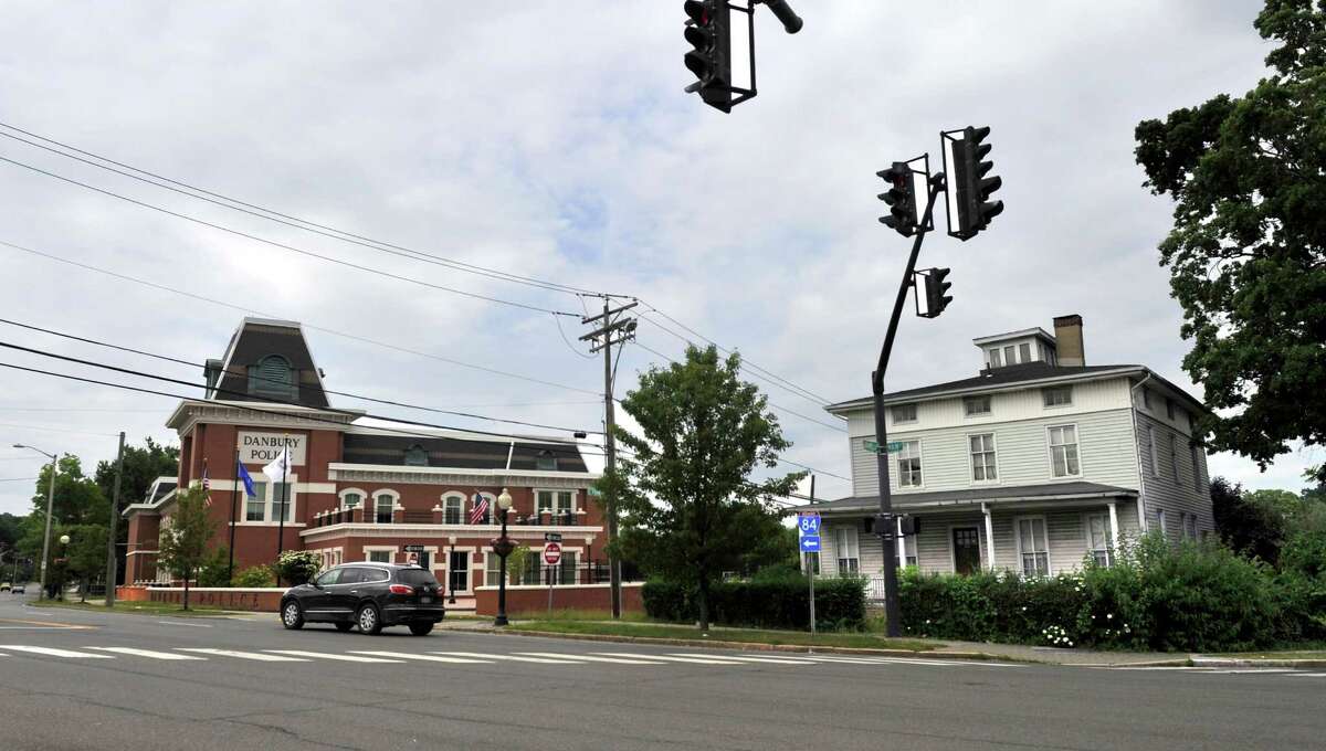 A city police officer who was killed by a hit-and-run driver as he rode his bicycle to work four years ago will be honored with other fallen officers and city firefighters under a plan by the City Council to knock down an abandoned house on Main Street, pictured right, and create a memorial park in Danbury, Conn. Monday, June 30, 2014.