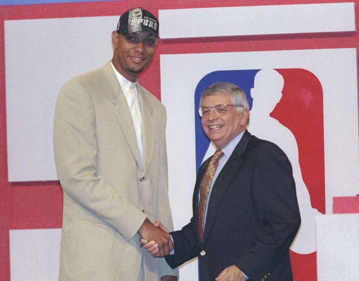 The classic Tim Duncan in a tan suit shakes hands with NBA Commissioner David Stern during the 1997 NBA Draft.