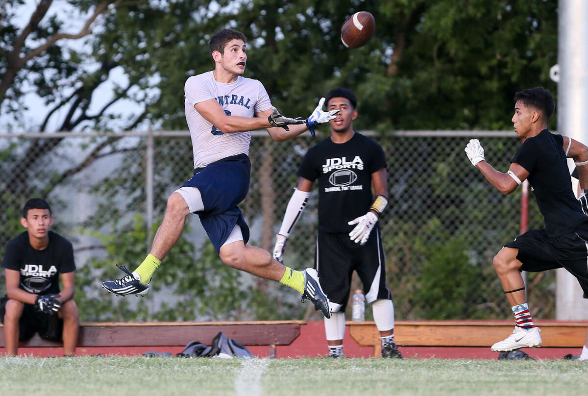 Central Catholic's Troy Lozano, second from left, leaps to catch a pass for a touchdown during the 7-on-7 championship game with Edison. Players say they see the value of spending five weeks in the summer working on their timing and execution.