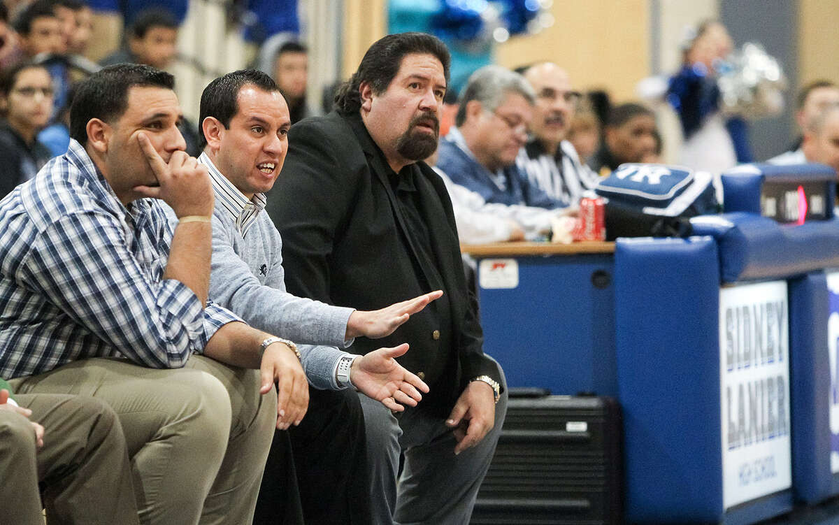 Then-assistant Lanier coach Joseph Martinez, second from left, gestures at players during a January game. Martinez has been named Voks basketball coach, succeeding retiring Rudy Bernal (in black). At left is returning assistant coach Martin Cardenas.
