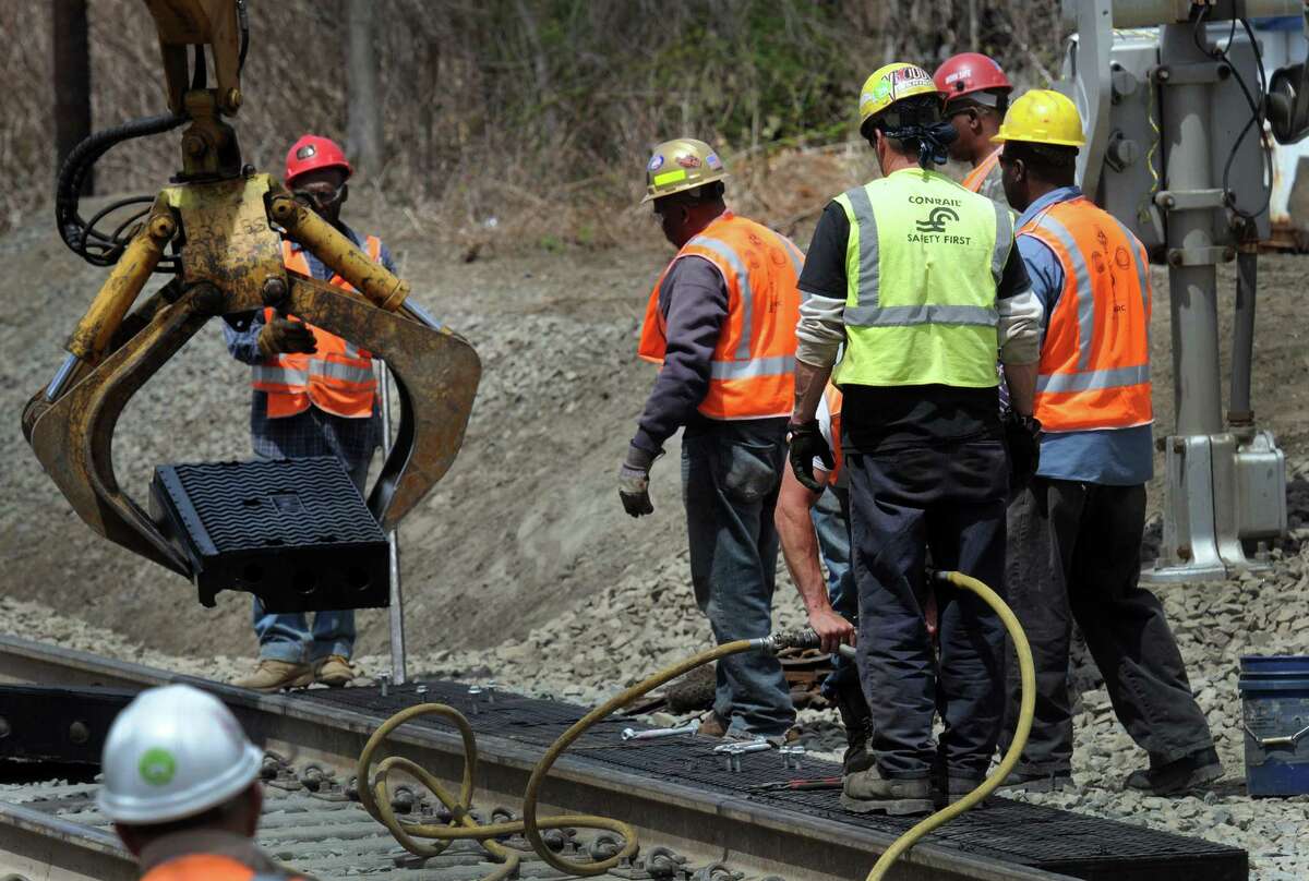 Crews are working Wednesday, May 7, 2014, to repair the railroad crossings on the Danbury branch of the Metro-North line.