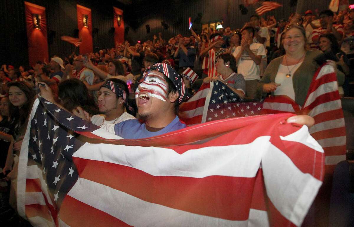 Rudy Rosales waves the U.S. flag as he joins hundreds of other soccer fans to watch the United States team play Belgium in the World Cup match on Tuesday, July 1, 2014 at the Palladium Theaters. The loud and raucous chants and cheers for the team by the supporters were eventually stifled as Belgium managed a 2-1 victory over the United States.