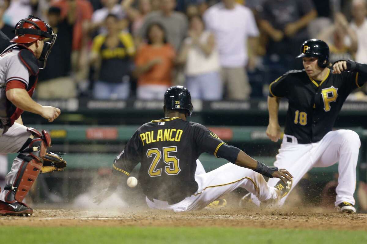 Pittsburgh's Gregory Polanco scores behind Neil Walker (right) on a game-tying double in the ninth.