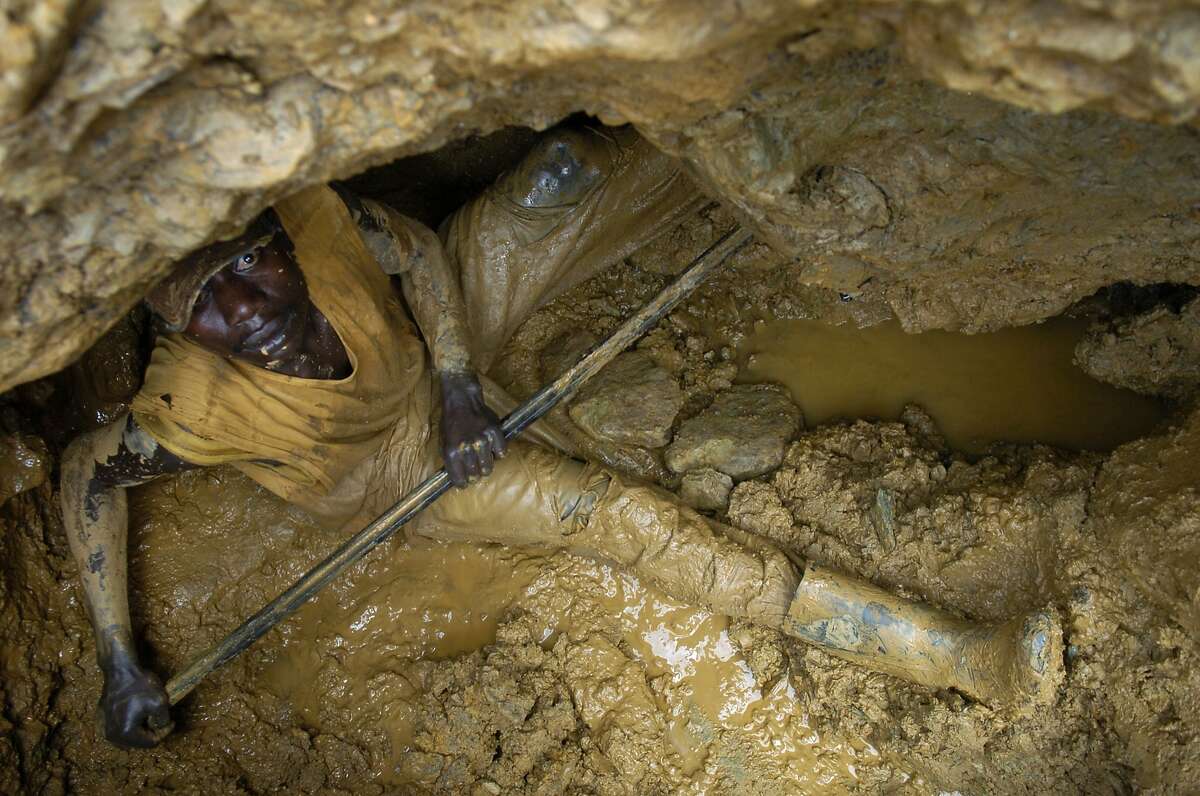 MONGWALU, CONGO Ð JUNE 9: A man at the bottom of a gold mine uses a long metal rod to jab away at the rock, mud and dirt in the hopes to discover a vein of gold running through the hills of the northeastern Democratic Republic of Congo on June 9, 2006. Although the Congo is one of the richest countries in the world in terms of mineral wealth, most people still live without running water or electricity. Photo by Daniel Pepper/Special to The Chronicle