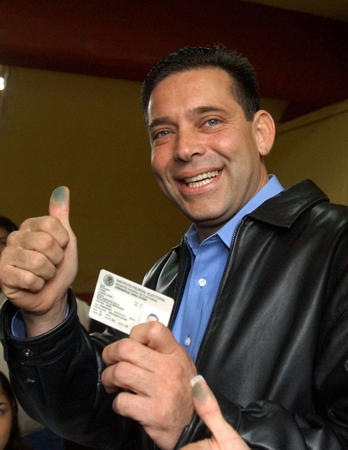 Institutional Revolutionary Party ( PRI) governor candidate for the state of Tamaulipas Eugenio Hernandez shows the ink on his finger after casting his vote Sunday, Nov. 14, 2004, in Ciudad Victoria, Mexico. Mexico's former ruling party was poised to extend its comeback this year in state elections, as residents of four states went to the polls to choose new governors on Sunday.