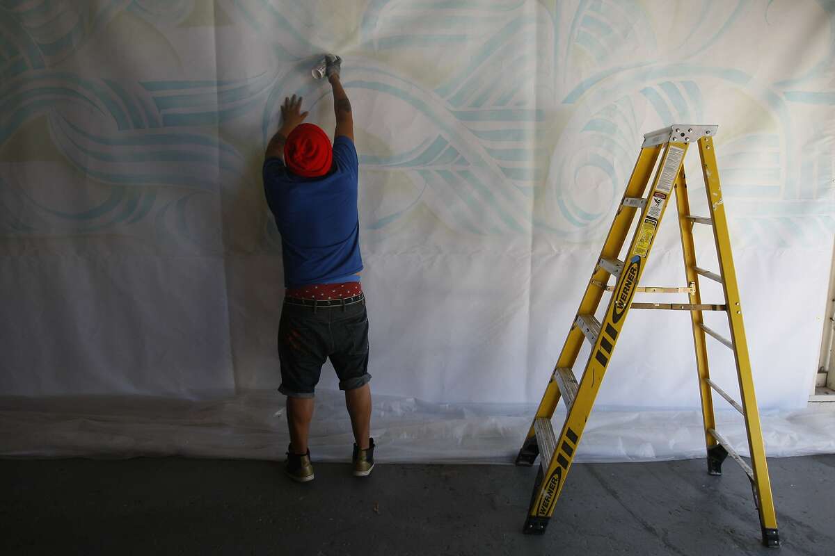 Artist Bounce Perez works on his his mural inside the Oakland Terminal artist space on June 27, 2014 in Oakland, CA. Bounce Perez is making a giant mural that will hang on the exterior of YBCA as part of Bay Area Now show in San Francisco.