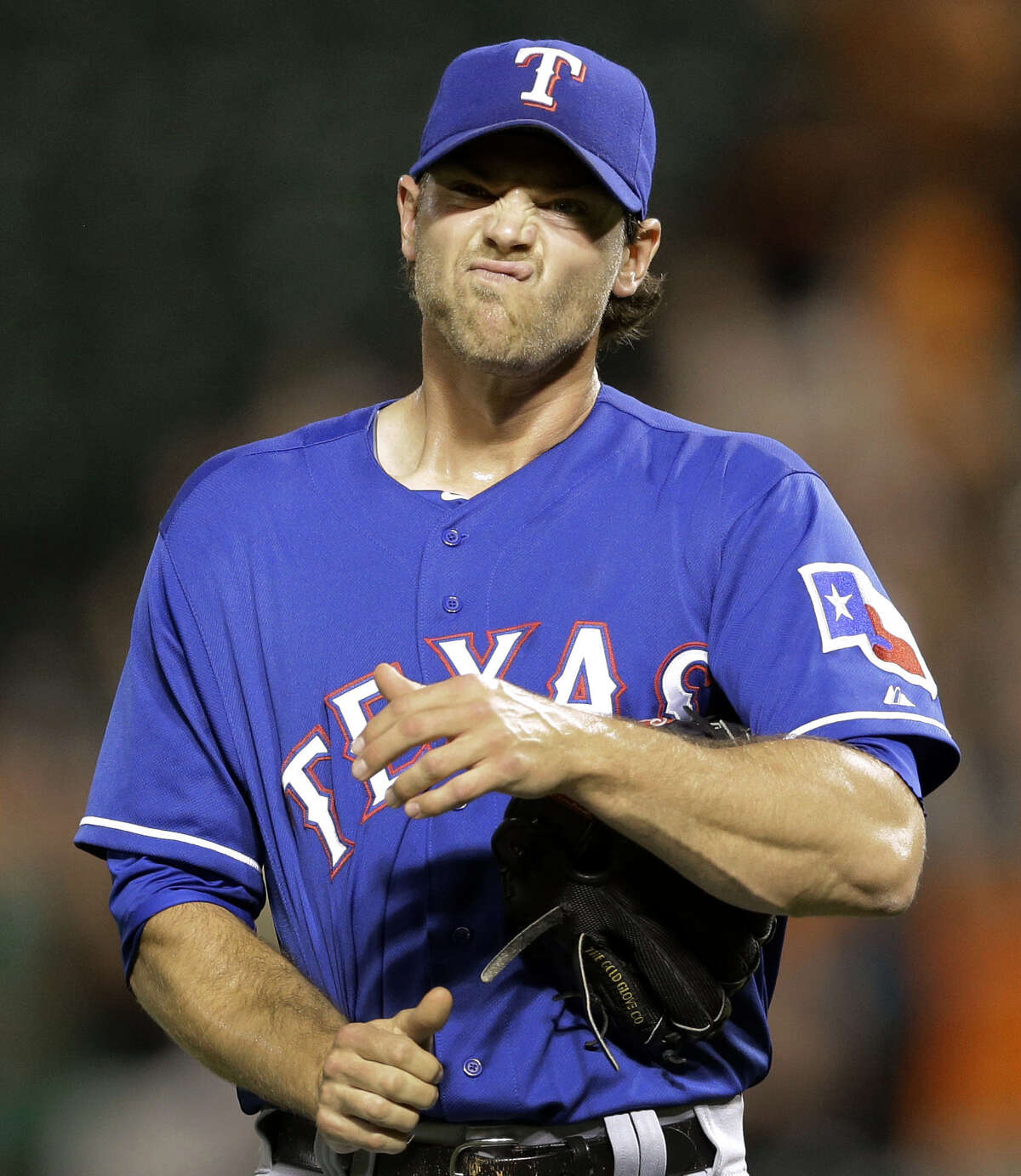 Texas reliever Neal Cotts wears a pained look on his face after giving up a go-ahead homer to Baltimore's Ryan Flaherty in the seventh inning.