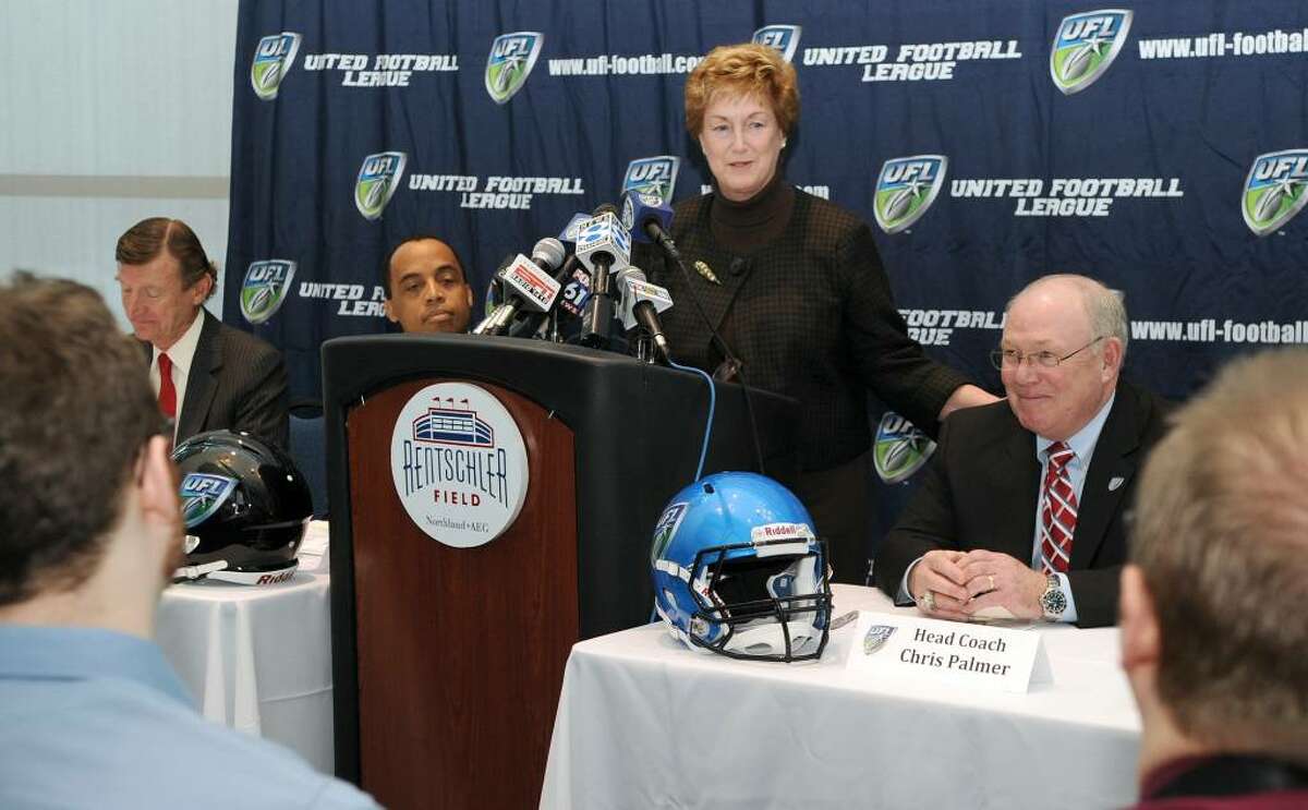 Governor M. Jodi Rell addresses a press conference Tuesday at the Rentschler Field in East Hartford, announcing Chris Palmer, right, as the new head coach of the United Football League's Hartford Team. Also left to right are, Bill Mayor, the team owner and Michael Huyghue, commissioner of the UFL.
