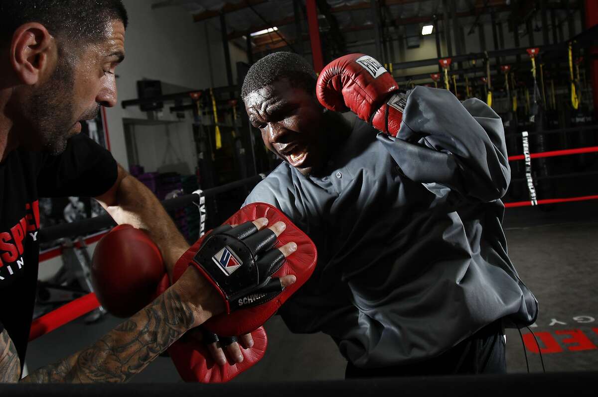 San Francisco 49ers running back Frank Gore spars with Brian Schwartz, his trainer and the owner of Undisputed Boxing Gym in San Carlos, Calif., on Saturday, June 28, 2014.