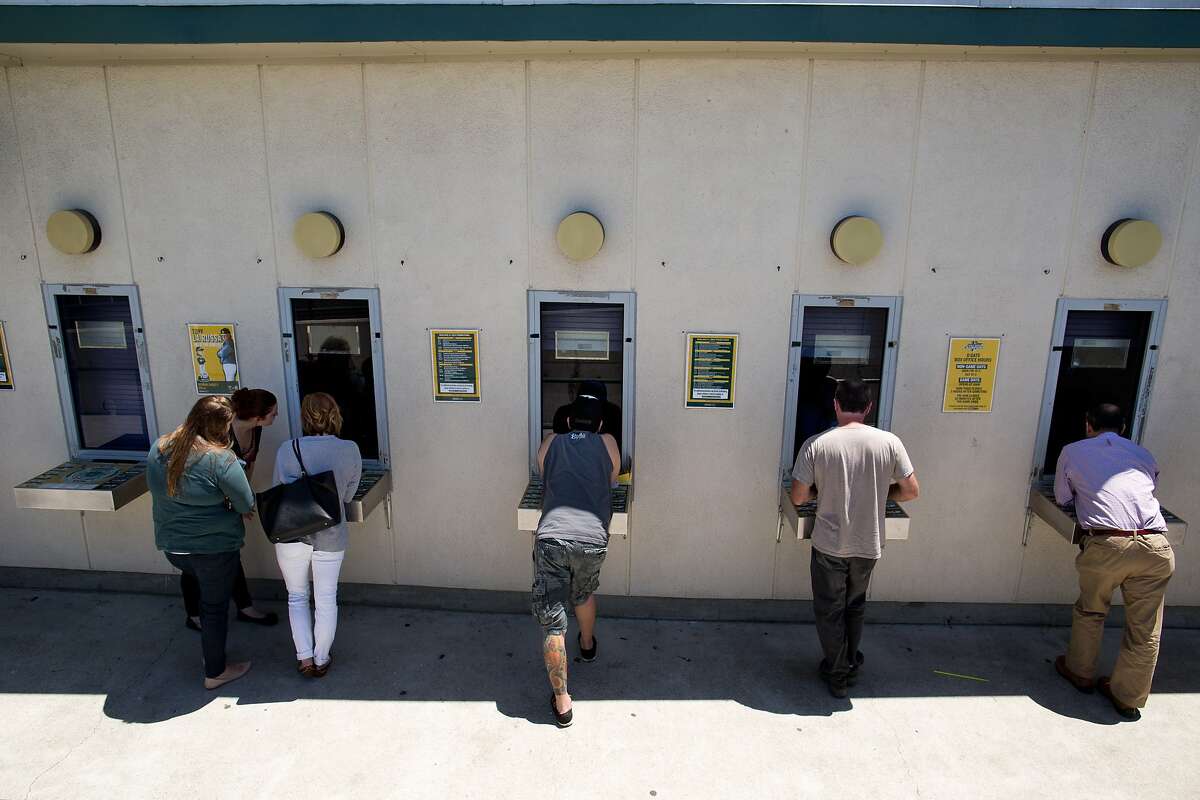 People buy tickets at a ticket booth outside the O.co Coliseum in Oakland, Calif. on Thursday, July 3, 2014.