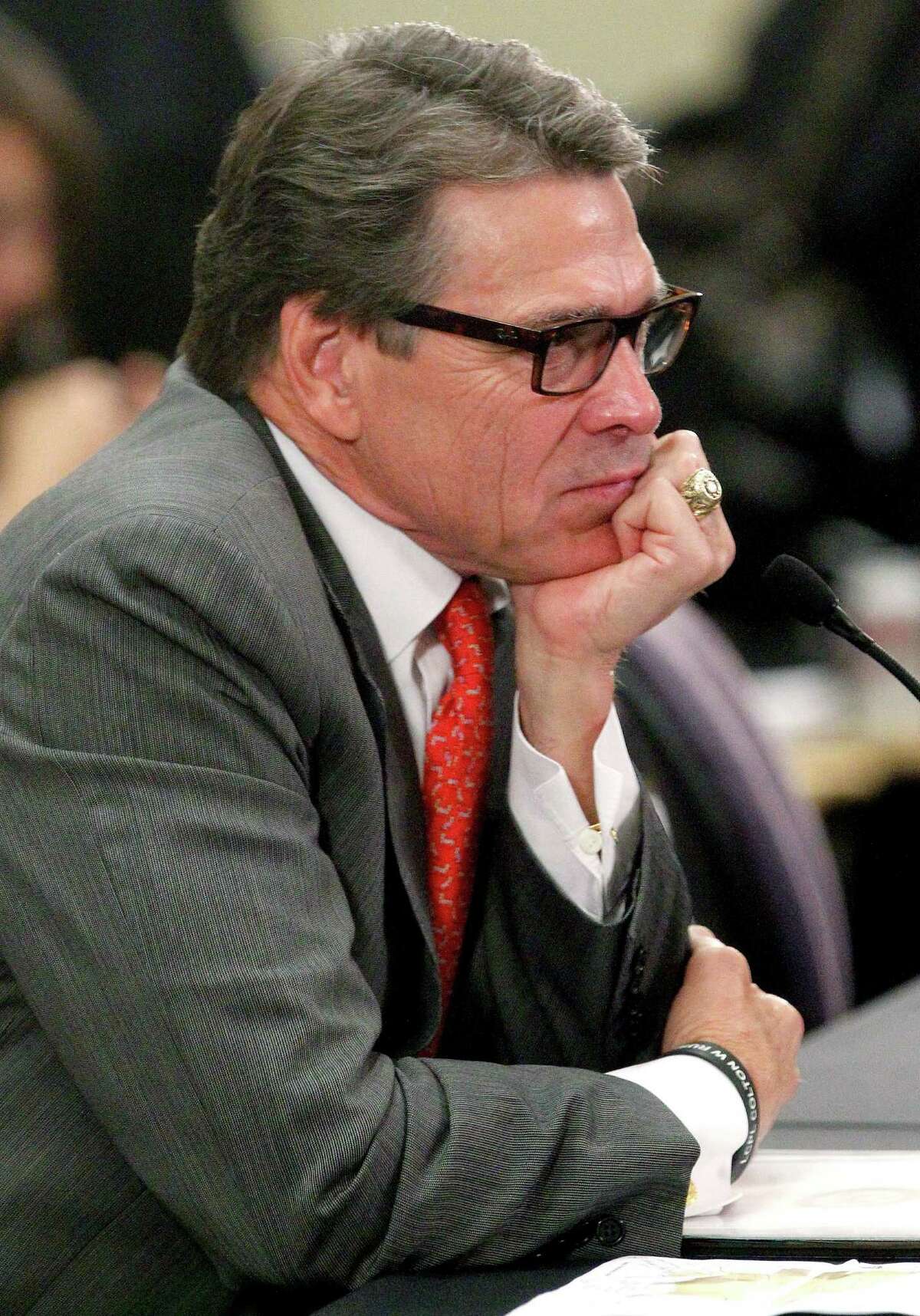 Texas Gov. Rick Perry listens to members of the U.S. House Committee on Homeland Security about the humanitarian and national security crises going on along the Texas-Mexico border Thursday July 3, 2014 in McAllen, Texas. Perry said that the tens of thousands of Central American children entering the U.S. illegally is both a humanitarian crisis and a national security one. (AP Photo/The Monitor, Gabe Hernandez) MAGS OUT; TV OUT