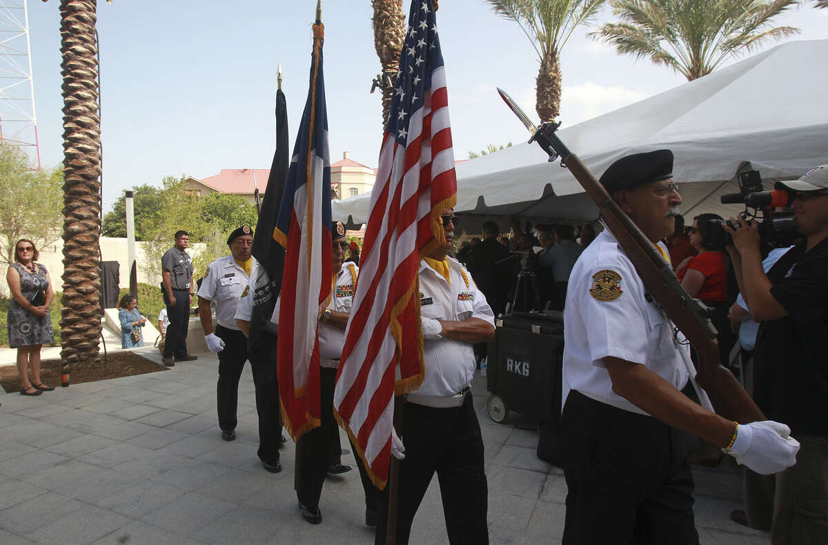 Members of the color guard from the Veterans of Foreign War Post 76 march at the Medal of Honor River Portal during the memorial's grand opening.
