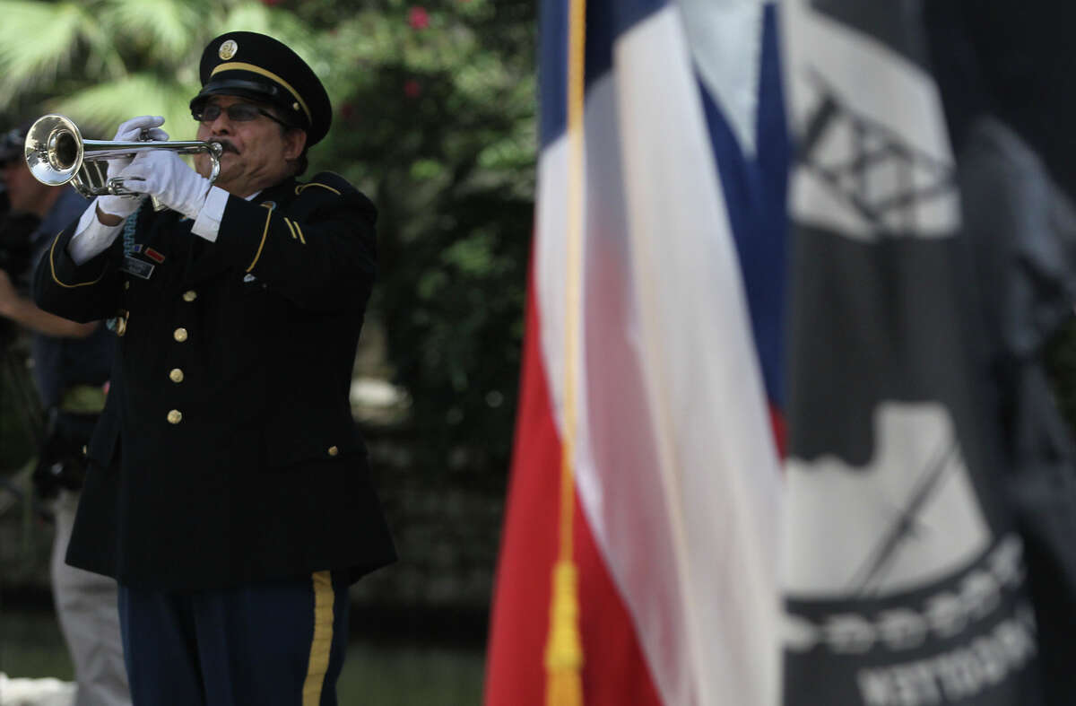 Taps is played Thursday July 3, 2014 during grand opening ceremonies for the new Medal of Honor River Portal located between the San Antonio River and the Tobin Center for the Performing Arts. The memorial pays homage to 32 Medal of Honor recipients from the San Antonio area.