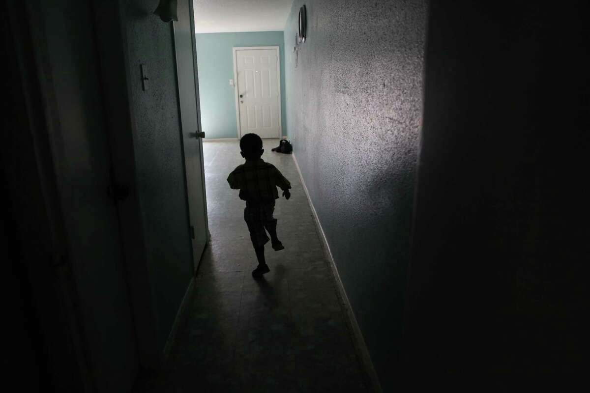 Prince Sawbo, 3, runs around his apartment as he awaits heart surgery at the end of this month on July 2, 2014, in Houston, Tx. Princess Sawbo, a refugee from Liberia, naturalized in April of this year with a fee waiver. Her U.S.-born son, Prince Sawbo, has had severe health complications throughout his life that prevent Princess from working.