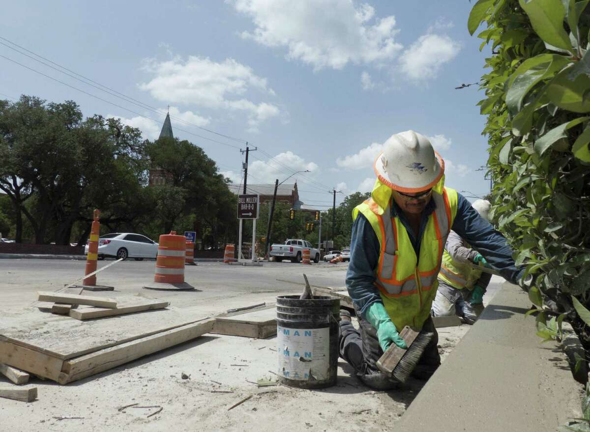 Carlos Torres works on July 3, 2014 on a concrete wall that's part of the project to improve storm drainage and traffic flow on Broadway near the University of the Incarnate Word.