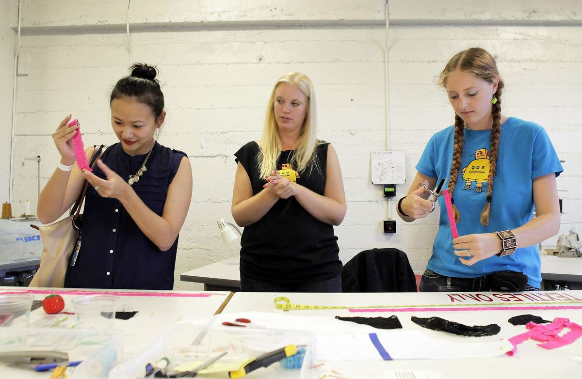 Karen Howard with Instructables, center, helps Rachel Liu, left, and Nichole Smith, right, with handcrafting some underwear at Techshop on Wednesday during a Girl Geek Dinner. Autodesk and Instructables hosted Girl Geek Dinner at Techshop in San Francisco, Calif., on Wednesday, August 14, 2013, where women interested in tech and networking were given a tour of the facility and heard from Brit Morin, the founder of Brit & Co.