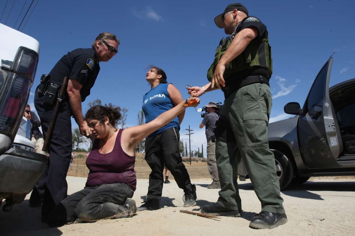 Counter-demonstrators to protesters opposing arrivals of buses carrying largely women and children undocumented migrants for processing at the Murrieta Border Patrol Station are detained on July 4, 2014 in Murrieta, Calif.