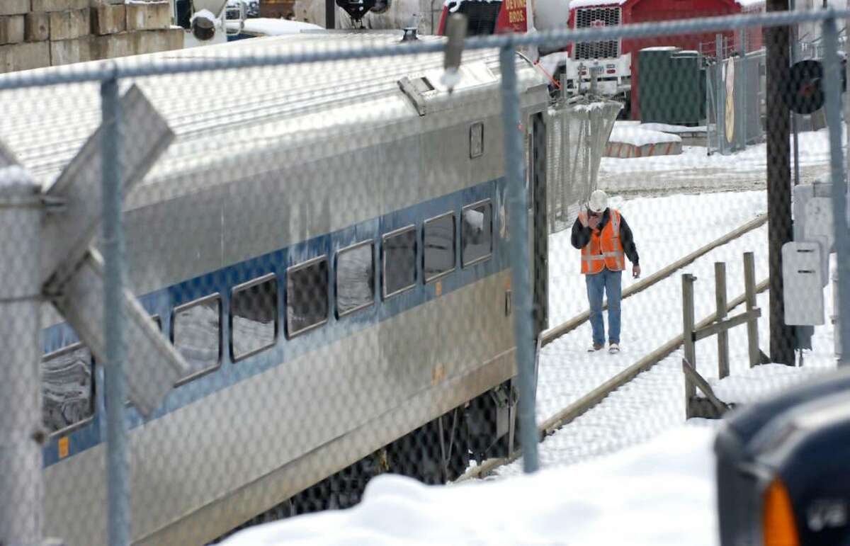 An official inspects the tracks during the aftermath of a fatal-incident where a Metro-North train appeared to have hit and killed a person Wednesday morning, Feb. 17th, 2010, as the train crossed Commerce Street just north of the Devine Bros. Inc. fuel depot., in central Norwalk.