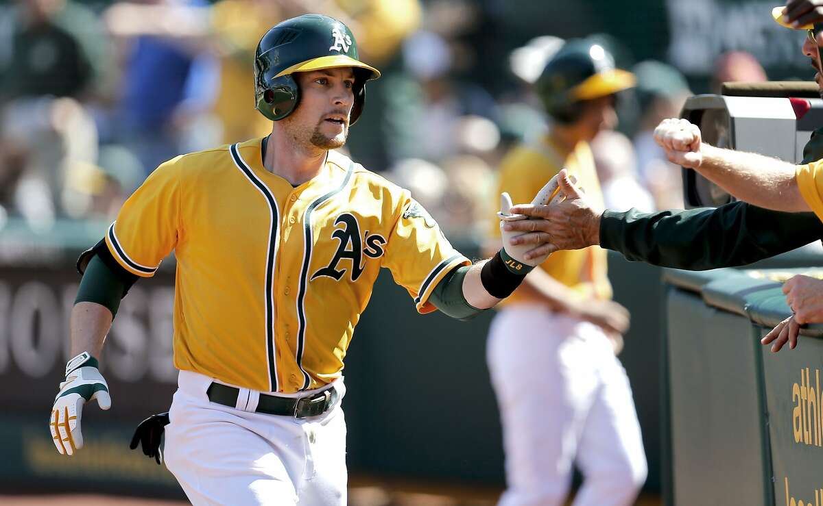 A's Jed Lowrie, (8) gave the team a spark in the bottom of the 9th inning with a solo home run, as the Oakland Athletics went on to lose to the Seattle Mariners 3-1 at the O.co Coliseum on Saturday April 5, 2014, in Oakland, Calif.