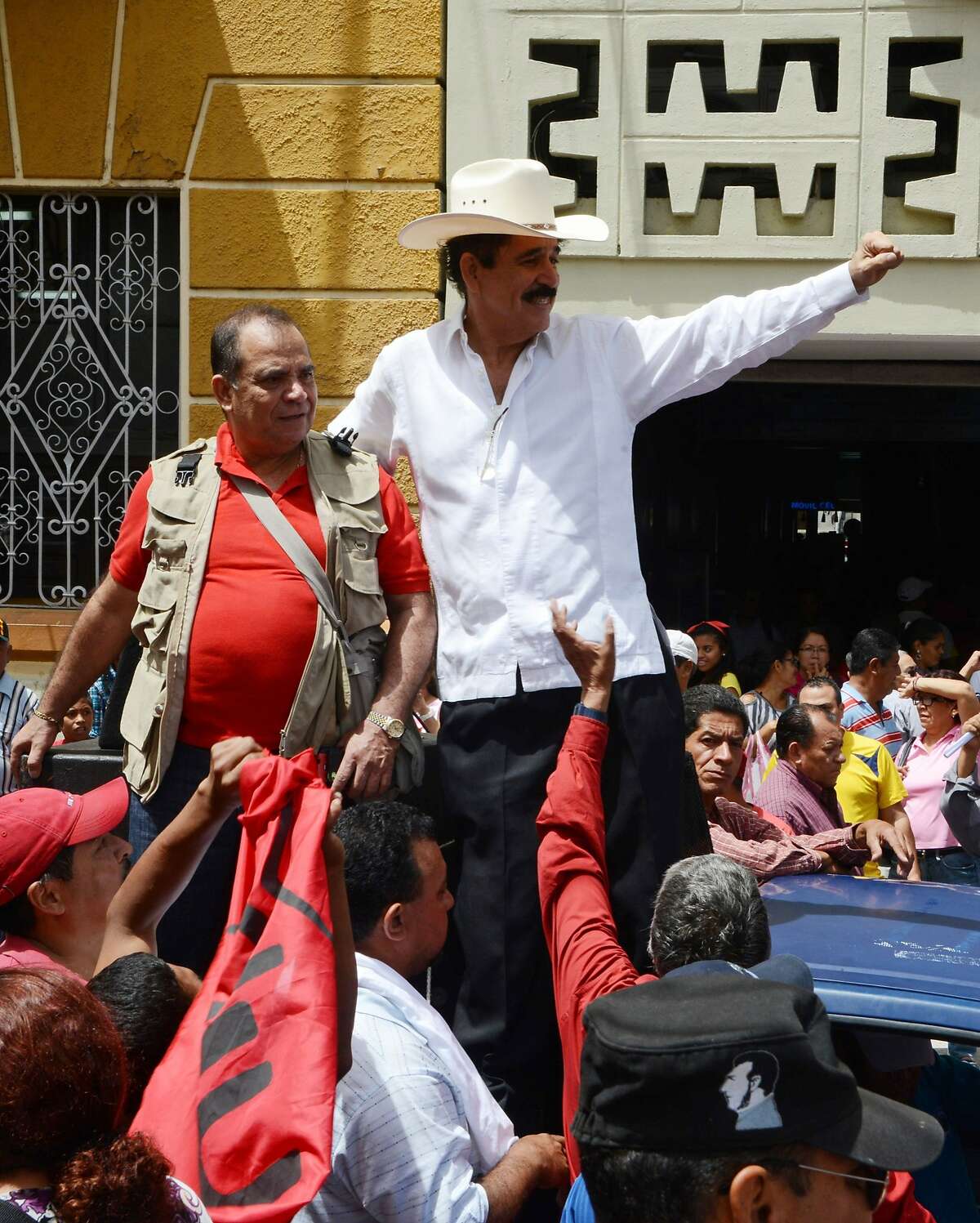 Honduras former President Manuel Zelaya (R) greets supporters of Libertad y Refundacion (LIBRE) and the Frente Nacional de Resistencia Popular (FNRP) parties during n a rally to commemorate five years of the coup which ousted him, in Tegucigalpa, on Juen 28, 2014. AFP PHOTO/Orlando SIERRAORLANDO SIERRA/AFP/Getty Images